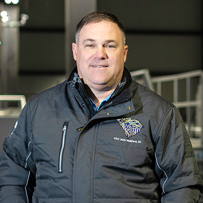 Walmart general manager James Bright wears a black jacket and smiles.